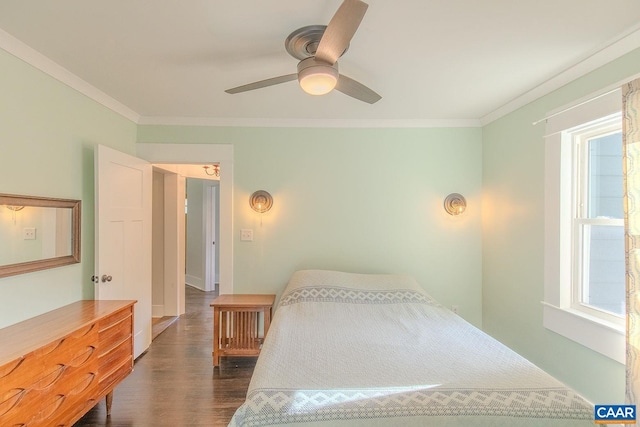 bedroom with dark wood-type flooring, a ceiling fan, baseboards, and crown molding