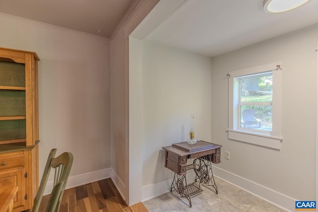 interior space featuring baseboards and crown molding