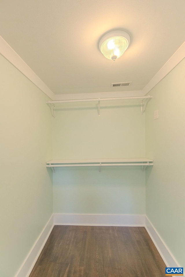 spacious closet featuring visible vents and wood finished floors