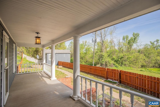 deck featuring fence and covered porch