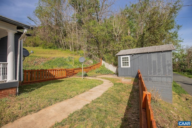 view of yard with fence and an outbuilding