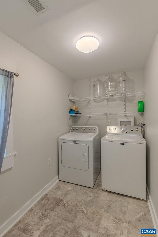 washroom with baseboards, laundry area, independent washer and dryer, and visible vents