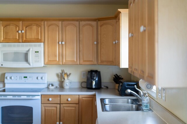 kitchen with sink and white appliances