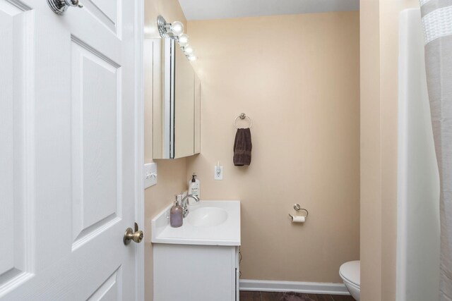 bathroom featuring vanity and toilet