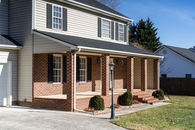 view of front facade featuring a porch and a garage