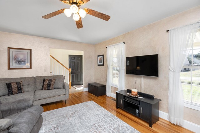 living room with hardwood / wood-style flooring and ceiling fan