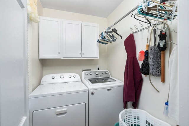 laundry room with cabinets and separate washer and dryer