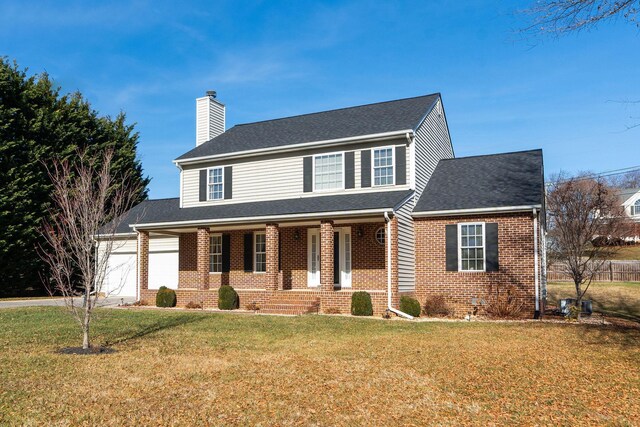 view of front of house with a porch, a garage, and a front lawn