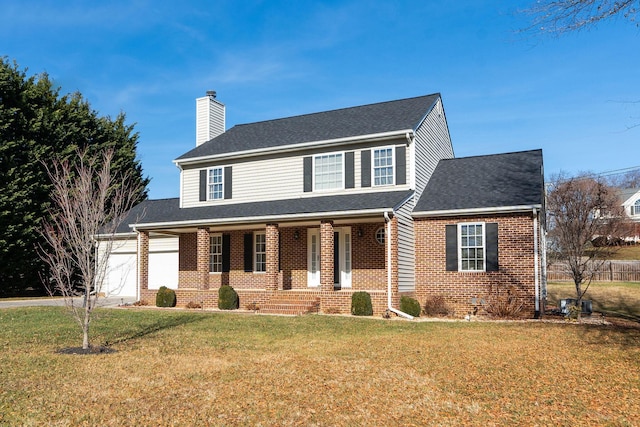 view of front of house with a porch, a garage, and a front lawn