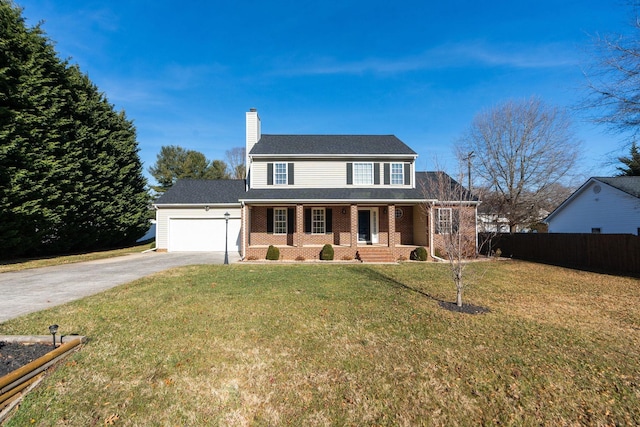 colonial home with a porch, a garage, and a front lawn