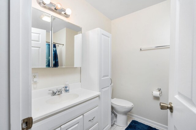 bathroom with vanity, toilet, and tile patterned flooring