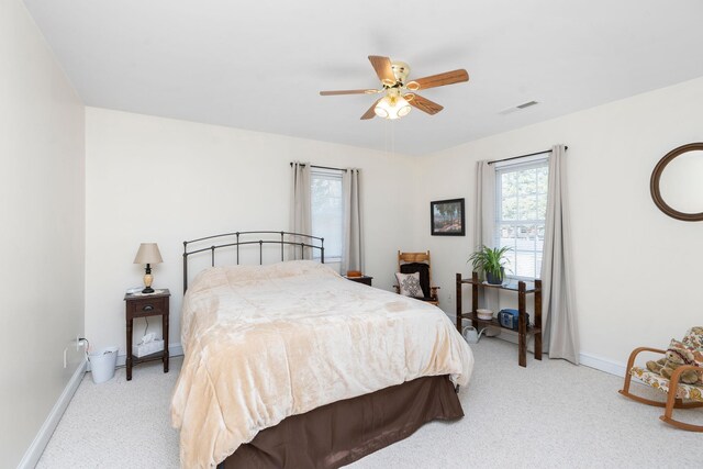 bedroom with light colored carpet and ceiling fan