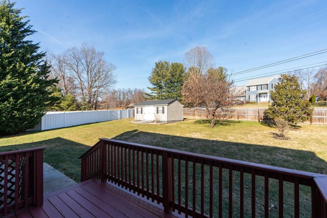 wooden terrace with a lawn and a storage unit