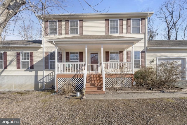 colonial-style house with a garage and covered porch