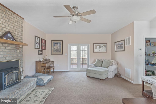 carpeted living room with french doors and ceiling fan