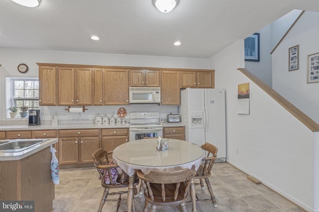 kitchen featuring white appliances and sink