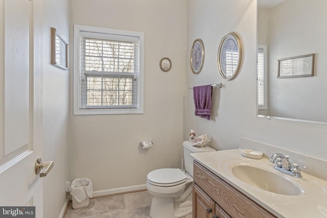 bathroom featuring tile patterned floors, vanity, and toilet