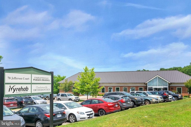 view of car parking featuring a yard