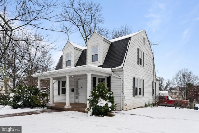 cape cod-style house with a porch