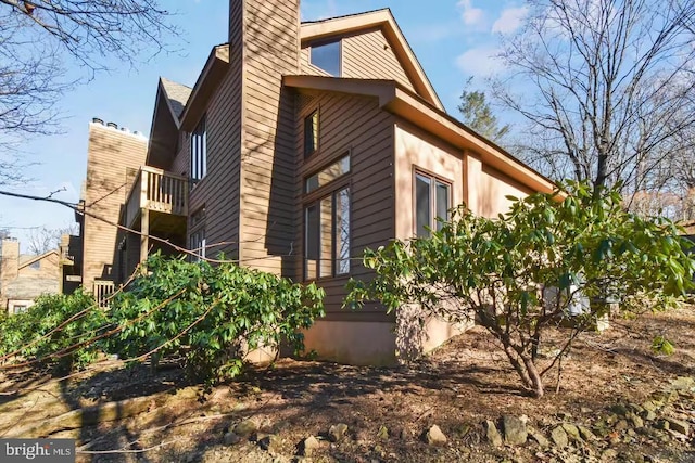 view of property exterior featuring a chimney