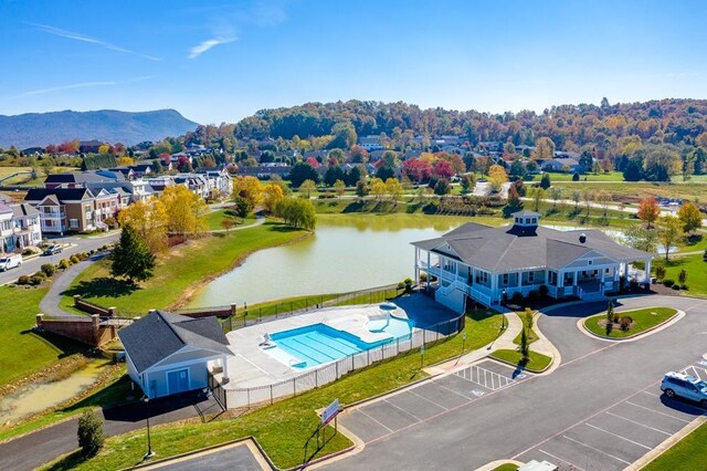 drone / aerial view featuring a water and mountain view