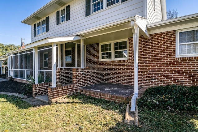 entrance to property with a lawn