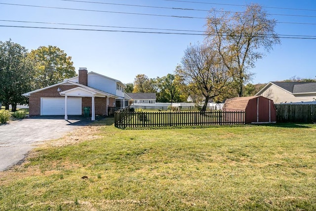 view of yard featuring a garage and a storage unit