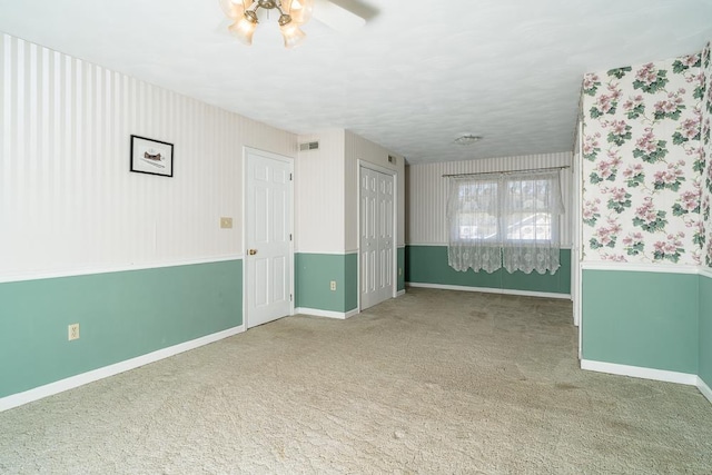 empty room with carpet and ceiling fan