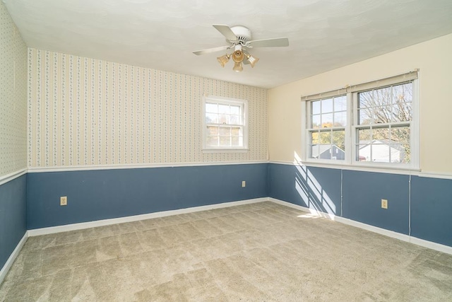 empty room featuring carpet floors and ceiling fan