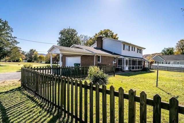 view of front of property featuring a sunroom and a front yard