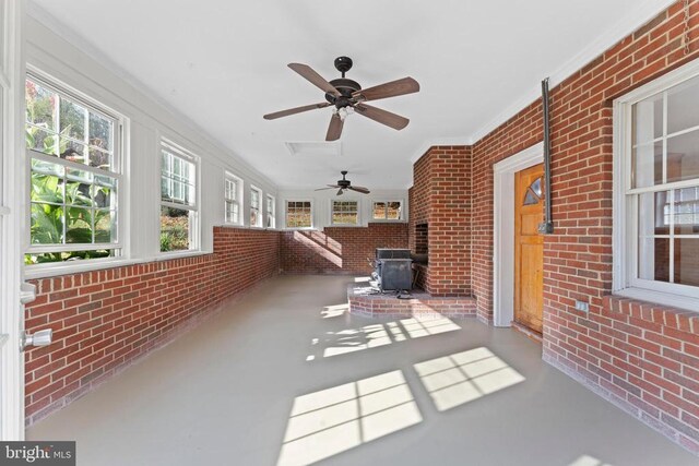 unfurnished sunroom featuring a wood stove