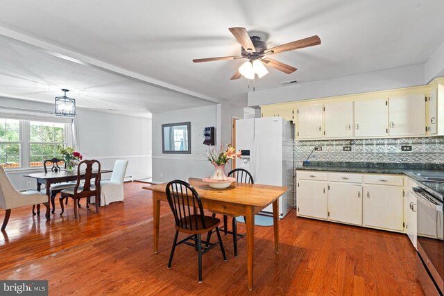 dining space with hardwood / wood-style flooring, ceiling fan with notable chandelier, and a wealth of natural light