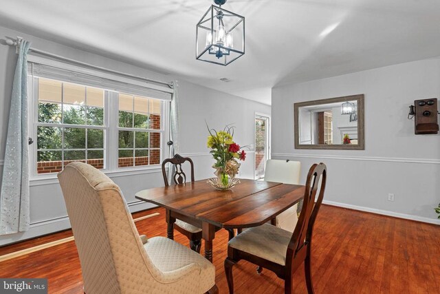 dining room with a baseboard radiator, dark hardwood / wood-style floors, and a chandelier