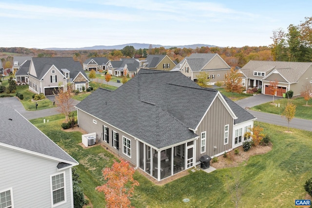 drone / aerial view with a residential view and a mountain view