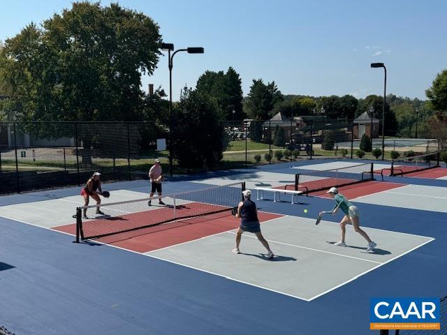 view of sport court featuring community basketball court and fence