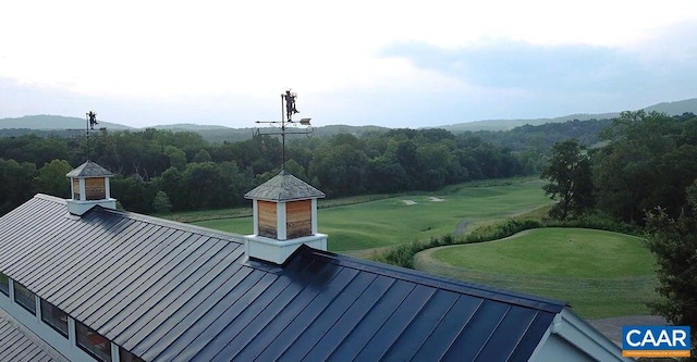 exterior space featuring a standing seam roof and golf course view