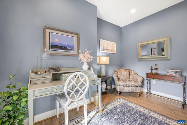 office area featuring baseboards and wood finished floors