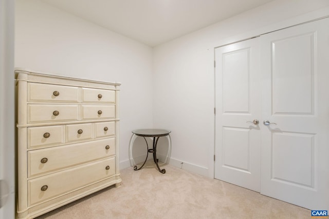 interior space with light carpet and baseboards