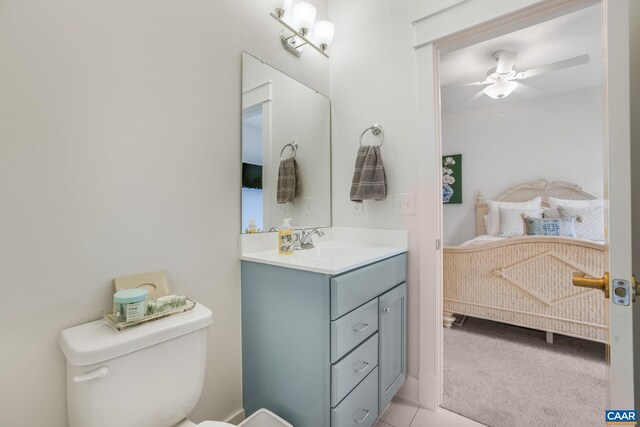 bathroom featuring toilet, ceiling fan, and vanity