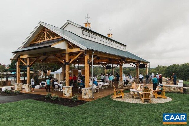 surrounding community with a lawn and a gazebo