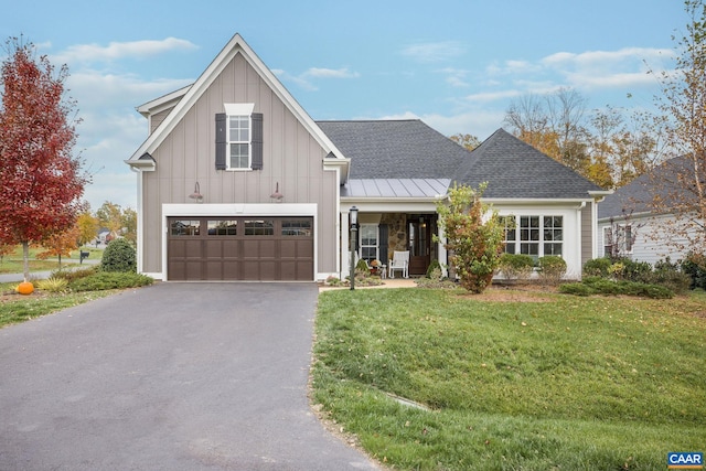 modern farmhouse style home featuring a shingled roof, driveway, board and batten siding, and a front lawn