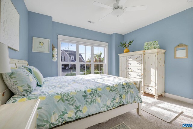 bedroom featuring carpet floors, visible vents, ceiling fan, and baseboards