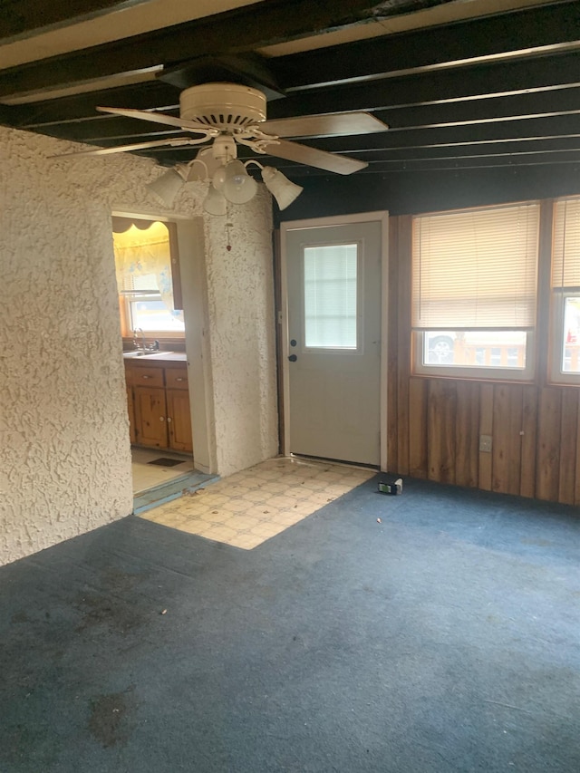 carpeted empty room with sink and ceiling fan