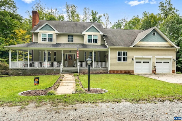 view of front of property featuring a garage, a front yard, and covered porch