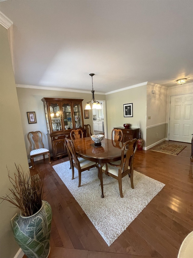 dining room featuring an inviting chandelier, crown molding, and dark hardwood / wood-style floors