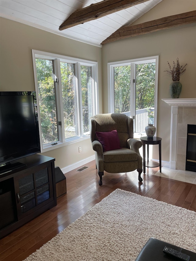 living room with hardwood / wood-style flooring, a fireplace, lofted ceiling with beams, and wooden ceiling