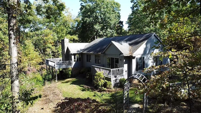 rear view of house with a wooden deck