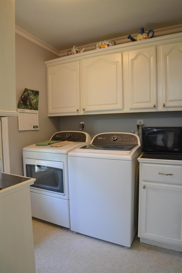 washroom featuring crown molding and washer and clothes dryer