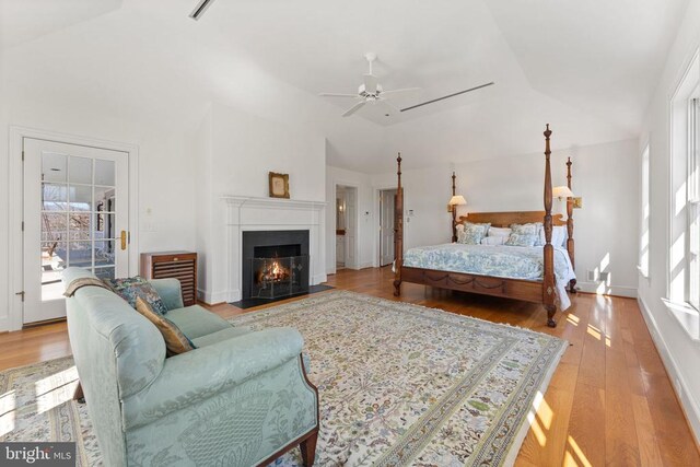 bedroom featuring ceiling fan, lofted ceiling, and light hardwood / wood-style flooring