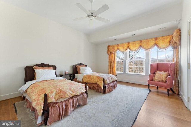 bedroom with ceiling fan and light hardwood / wood-style flooring